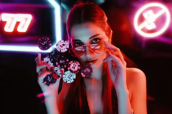 786BET Casino — Step inside our high-end casino experience A glamorous woman holding casino chips in a neon-lit environment, representing the premium online casino atmosphere of 786BET.